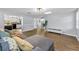 Spacious living area featuring wood-look flooring, a comfortable sofa, and modern decor at 7235 Astor Dr, New Port Richey, FL 34652
