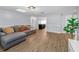 Open-concept living area with wood-look floors, neutral paint, and stylish furnishings at 7235 Astor Dr, New Port Richey, FL 34652