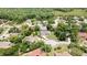 Aerial view of a single-Gathering home with a large yard, outlined in red, in a mature neighborhood at 7495 Birdland Cres, Spring Hill, FL 34607