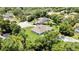Single-story home has a large backyard with a private pool and patio, surrounded by mature trees at 7495 Birdland Cres, Spring Hill, FL 34607
