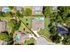 Aerial view of property with a pool and landscaping, outlined in red at 7495 Birdland Cres, Spring Hill, FL 34607