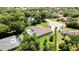 Aerial view of a beautiful home with a pool and lush green landscaping at 7495 Birdland Cres, Spring Hill, FL 34607