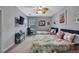Comfortable bedroom with two twin beds, ceiling fan, neutral walls and carpet at 7495 Birdland Cres, Spring Hill, FL 34607