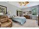 Cozy bedroom features recliner, twin bed, fan and storage solutions at 7495 Birdland Cres, Spring Hill, FL 34607