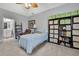 Cozy bedroom features recliner, twin bed, fan and storage solutions at 7495 Birdland Cres, Spring Hill, FL 34607