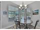 Dining area featuring a round table with seating and natural light at 7495 Birdland Cres, Spring Hill, FL 34607