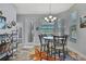 Cozy dining area with a round table, chandelier lighting, and view of the backyard at 7495 Birdland Cres, Spring Hill, FL 34607