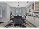 Formal dining room features a modern chandelier, elegant furnishings, and stylish built-in cabinets at 7495 Birdland Cres, Spring Hill, FL 34607