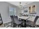 Chic dining room with stylish chairs, a modern chandelier, and elegant built-in display cabinets at 7495 Birdland Cres, Spring Hill, FL 34607