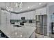 Spacious kitchen featuring white cabinets, stainless steel appliances, and a large island at 7495 Birdland Cres, Spring Hill, FL 34607