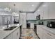 Modern kitchen with white cabinets, stainless steel appliances, a large island, and stylish decor at 7495 Birdland Cres, Spring Hill, FL 34607
