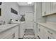 Bright laundry room boasts ample counter space, cabinetry, modern washer and dryer, and stylish rugs at 7495 Birdland Cres, Spring Hill, FL 34607
