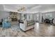 Elegant living room with a stone fireplace, tiled floors, and an open layout flowing into the dining area at 7495 Birdland Cres, Spring Hill, FL 34607