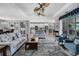Bright living room showcases modern decor, tray ceilings, and an open layout to dining and kitchen at 7495 Birdland Cres, Spring Hill, FL 34607