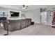 Spacious living room features a built-in entertainment center, neutral carpet and a fan at 7495 Birdland Cres, Spring Hill, FL 34607