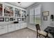 Bright office with built-in bookshelves, white cabinets, and a large window with plantation shutters at 7495 Birdland Cres, Spring Hill, FL 34607