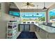 Entertain outdoors with a fully-equipped kitchen, featuring stainless steel appliances, granite counters, and ample bar seating at 7495 Birdland Cres, Spring Hill, FL 34607