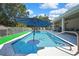 Relax and enjoy the Florida lifestyle in this spacious pool with a built-in table and plenty of room for entertaining at 7495 Birdland Cres, Spring Hill, FL 34607