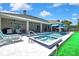 This home features a pool and spa, as well as outdoor seating, all in a spacious and stylish layout at 7495 Birdland Cres, Spring Hill, FL 34607