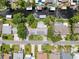 Aerial view of a residential neighborhood featuring waterfront homes with canal access and lush landscaping at 75 N Canal Dr, Palm Harbor, FL 34684