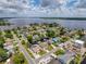 Scenic aerial view showcasing a waterfront community with houses, canals, and lake access at 75 N Canal Dr, Palm Harbor, FL 34684