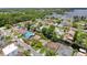 Aerial shot of a waterfront community featuring canal access, private pools, and lush, mature trees at 75 N Canal Dr, Palm Harbor, FL 34684