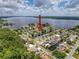 Aerial view of a waterfront community with houses and canals and a large lake in the background at 75 N Canal Dr, Palm Harbor, FL 34684
