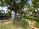 This backyard boasts a scenic waterfront view and mature trees at 75 N Canal Dr, Palm Harbor, FL 34684