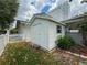 Backyard featuring a storage shed, pergola-covered patio, and well-manicured landscaping at 75 N Canal Dr, Palm Harbor, FL 34684