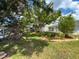 The spacious backyard features mature trees and swing sets at 75 N Canal Dr, Palm Harbor, FL 34684