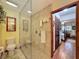 Bright bathroom with a glass-enclosed shower and neutral tile work leading to the bedroom at 75 N Canal Dr, Palm Harbor, FL 34684
