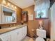 Bathroom featuring a white vanity, granite countertop, decorative accents and a window at 75 N Canal Dr, Palm Harbor, FL 34684