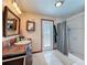 Full bathroom featuring wood vanity, walk-in shower, and tile flooring at 75 N Canal Dr, Palm Harbor, FL 34684