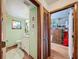 A charming half bathroom with a stained glass window, granite counters, and stylish accents at 75 N Canal Dr, Palm Harbor, FL 34684