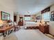 Traditional bedroom with a four-poster bed, wood furniture, and a view to the outside at 75 N Canal Dr, Palm Harbor, FL 34684