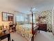 Charming bedroom with floral wallpaper, window views, and a four poster bed at 75 N Canal Dr, Palm Harbor, FL 34684
