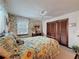 Charming bedroom featuring floral wallpaper and a comfortable bed with sunflower patterned bedding at 75 N Canal Dr, Palm Harbor, FL 34684