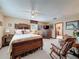 Spacious bedroom with neutral carpet, classic furnishings and a cozy seating area at 75 N Canal Dr, Palm Harbor, FL 34684