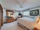 Bedroom with white bedding, a wooden dresser, and soft lighting, creating a relaxing and inviting atmosphere at 75 N Canal Dr, Palm Harbor, FL 34684