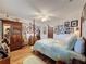 Cozy bedroom with a quilt-covered bed, wood floors, and photo gallery wall at 75 N Canal Dr, Palm Harbor, FL 34684