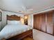 Bedroom featuring a bed with wooden frame, ceiling fan, and a closet with bi-fold doors at 75 N Canal Dr, Palm Harbor, FL 34684