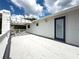 Large rooftop deck with white railings and a pergola, perfect for outdoor entertaining and relaxation at 75 N Canal Dr, Palm Harbor, FL 34684