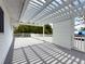 Covered rooftop deck featuring white railings and pergola, offering a shaded outdoor space for leisure at 75 N Canal Dr, Palm Harbor, FL 34684
