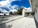 Expansive rooftop deck with white railings, arbor, and views of the neighborhood at 75 N Canal Dr, Palm Harbor, FL 34684