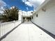 Wide-angle view of a rooftop deck, highlighting its white railings and pergola for outdoor enjoyment at 75 N Canal Dr, Palm Harbor, FL 34684