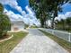 Long driveway to home bordered by white picket fence at 75 N Canal Dr, Palm Harbor, FL 34684