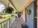 Charming covered front porch featuring brick accents, a welcome wreath, and a paved walkway at 75 N Canal Dr, Palm Harbor, FL 34684