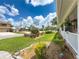 Manicured front yard with brick accents, landscaping, and charming home in a Gathering-friendly neighborhood at 75 N Canal Dr, Palm Harbor, FL 34684