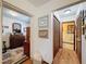 Hallway featuring access to the bedroom and bathroom, with art on the walls at 75 N Canal Dr, Palm Harbor, FL 34684
