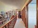 Upstairs hallway featuring a chandelier, warm lighting and multiple storage closets at 75 N Canal Dr, Palm Harbor, FL 34684